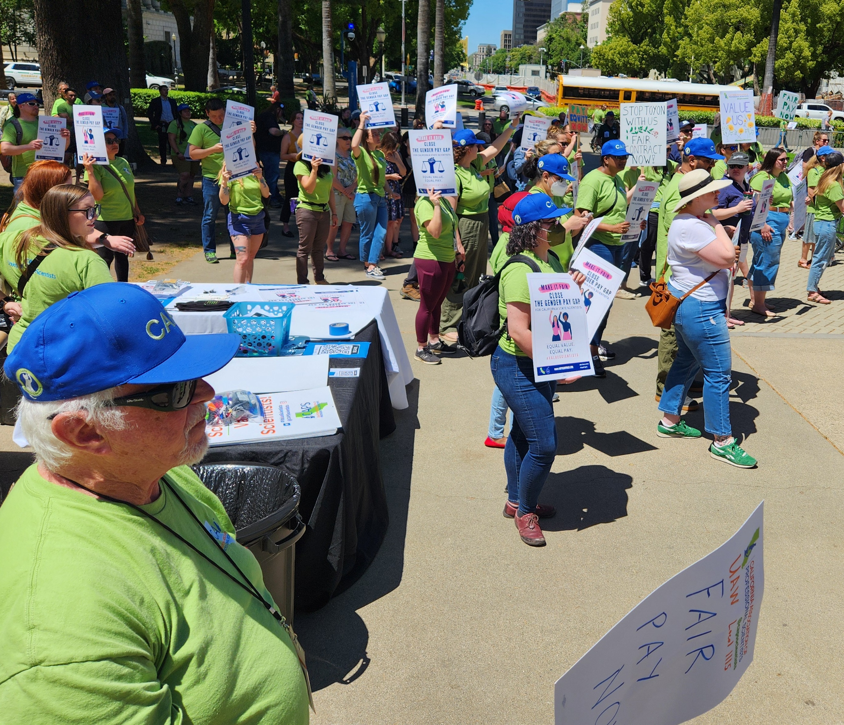 Union members and allies wearing CAPS shirts gathered on the Capitol steps.